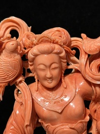A Chinese red coral Xiwangmu on wooden stand, 19/20th C.