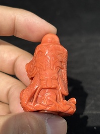 A Chinese carved red coral 'dragon' snuff bottle on wooden stand, 19/20th C.