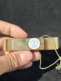 A Chinese jade 'chrysanthemum' bowl, an archer's ring and a belt hook, Ming/Qing