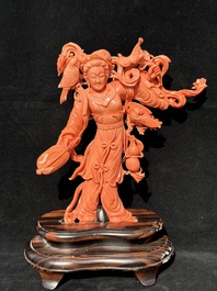 A Chinese red coral Xiwangmu on wooden stand, 19/20th C.