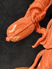 A Chinese red coral Xiwangmu on wooden stand, 19/20th C.