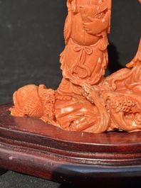 A Chinese red coral 'Sanxing' group on wooden stand, 19/20th C.