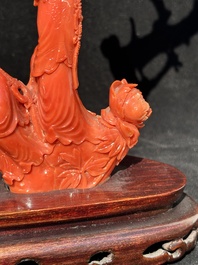 A Chinese carved red coral group with goddesses on wooden stand, 19/20th C.