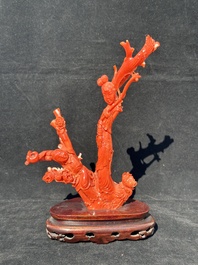 A Chinese carved red coral group with goddesses on wooden stand, 19/20th C.