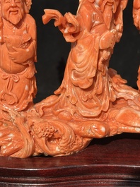A Chinese red coral 'Sanxing' group on wooden stand, 19/20th C.