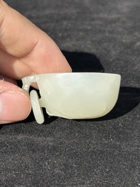 A Chinese white jade cup and two rings, Qing