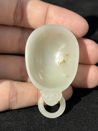 A Chinese white jade cup and two rings, Qing
