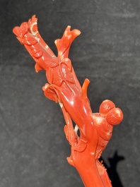 A Chinese carved red coral group with goddesses on wooden stand, 19/20th C.
