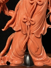A Chinese red coral Xiwangmu on wooden stand, 19/20th C.