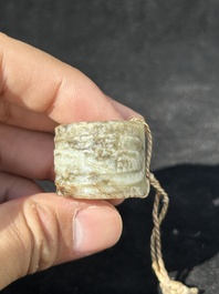 A Chinese jade 'chrysanthemum' bowl, an archer's ring and a belt hook, Ming/Qing