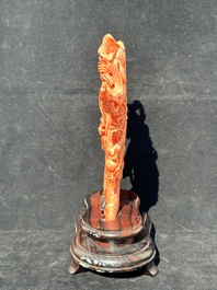 A Chinese red coral Xiwangmu on wooden stand, 19/20th C.