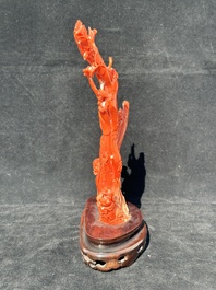 A Chinese carved red coral group with goddesses on wooden stand, 19/20th C.