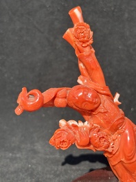 A Chinese carved red coral group with goddesses on wooden stand, 19/20th C.