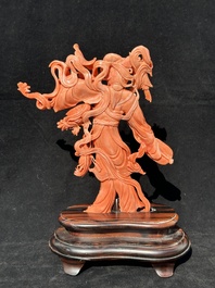A Chinese red coral Xiwangmu on wooden stand, 19/20th C.