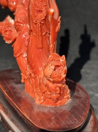 A Chinese carved red coral group with goddesses on wooden stand, 19/20th C.