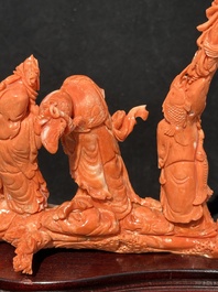 A Chinese red coral 'Sanxing' group on wooden stand, 19/20th C.