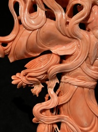 A Chinese red coral Xiwangmu on wooden stand, 19/20th C.