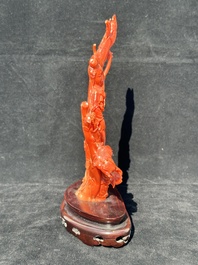 A Chinese carved red coral group with goddesses on wooden stand, 19/20th C.