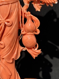 A Chinese red coral Xiwangmu on wooden stand, 19/20th C.