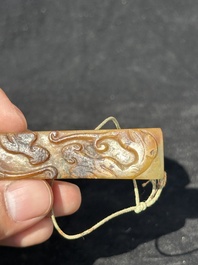 A Chinese jade 'chrysanthemum' bowl, an archer's ring and a belt hook, Ming/Qing