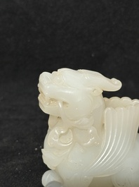 A Chinese white jade carving of a mythic animal, 19/20th C.
