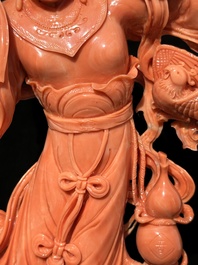A Chinese red coral Xiwangmu on wooden stand, 19/20th C.