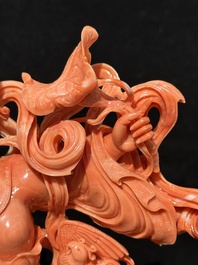 A Chinese red coral Xiwangmu on wooden stand, 19/20th C.