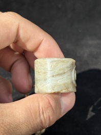 A Chinese jade 'chrysanthemum' bowl, an archer's ring and a belt hook, Ming/Qing