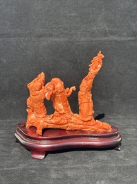 A Chinese red coral 'Sanxing' group on wooden stand, 19/20th C.