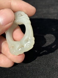 A Chinese white jade cup and two rings, Qing