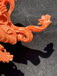 A Chinese red coral Xiwangmu on wooden stand, 19/20th C.