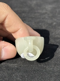 A Chinese white jade cup and two rings, Qing
