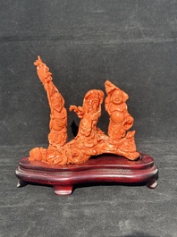 A Chinese red coral 'Sanxing' group on wooden stand, 19/20th C.