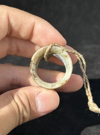 A Chinese jade 'chrysanthemum' bowl, an archer's ring and a belt hook, Ming/Qing