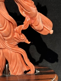 A Chinese red coral Xiwangmu on wooden stand, 19/20th C.
