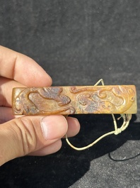 A Chinese jade 'chrysanthemum' bowl, an archer's ring and a belt hook, Ming/Qing