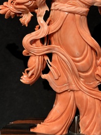 A Chinese red coral Xiwangmu on wooden stand, 19/20th C.