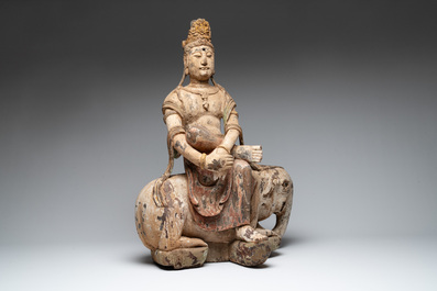 A large Chinese polychromed wooden Guanyin seated on an elephant, Republic