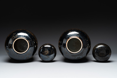 A pair of Chinese gilt-decorated mirror-black-glazed jars and covers on gilt bronze mounts, 19th C.