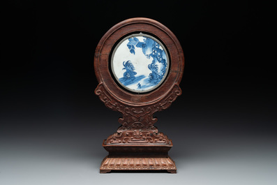 A Chinese blue and white 'Bleu de Hue' 'roosters and chick' plaque in a carved wooden screen and a bowl, 19th C.