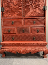 A Chinese cinnabar lacquer 'mountainous landscape' cabinet on a stand, 19th C.