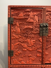 A Chinese cinnabar lacquer 'mountainous landscape' cabinet on a stand, 19th C.