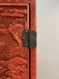 A Chinese cinnabar lacquer 'mountainous landscape' cabinet on a stand, 19th C.