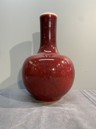 A Chinese apple-green-glazed and two copper-red-glazed bottle vases, Kangxi mark, 19/20th C.