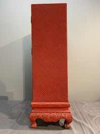 A Chinese cinnabar lacquer 'mountainous landscape' cabinet on a stand, 19th C.