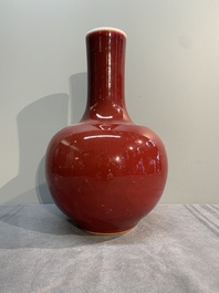 A Chinese apple-green-glazed and two copper-red-glazed bottle vases, Kangxi mark, 19/20th C.