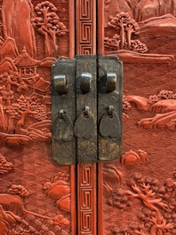 A Chinese cinnabar lacquer 'mountainous landscape' cabinet on a stand, 19th C.