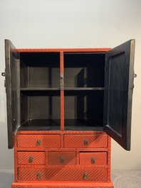 A Chinese cinnabar lacquer 'mountainous landscape' cabinet on a stand, 19th C.