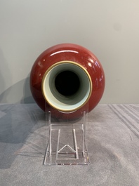 A Chinese apple-green-glazed and two copper-red-glazed bottle vases, Kangxi mark, 19/20th C.