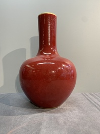A Chinese apple-green-glazed and two copper-red-glazed bottle vases, Kangxi mark, 19/20th C.